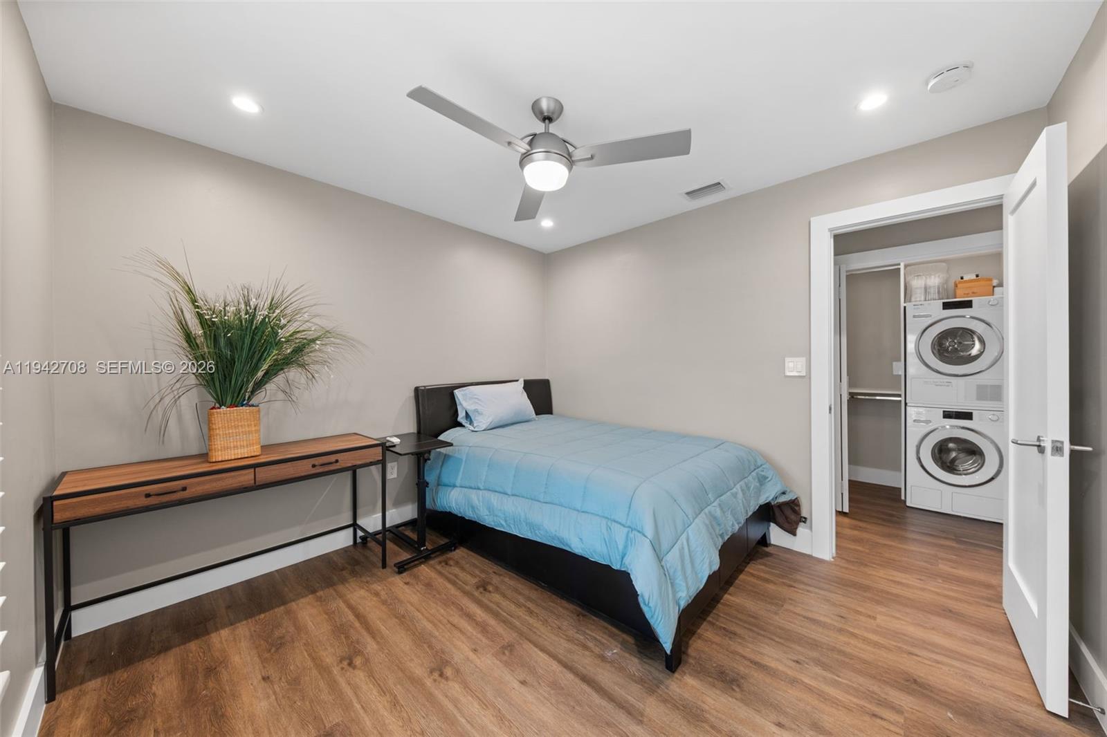 22239 Southwest 98th Place Cutler Bay, FL 33190 - Photo 32 of 67 a spacious bedroom with a bed and a chandelier