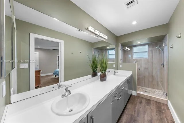 a kitchen with a white cabinets and wooden floor