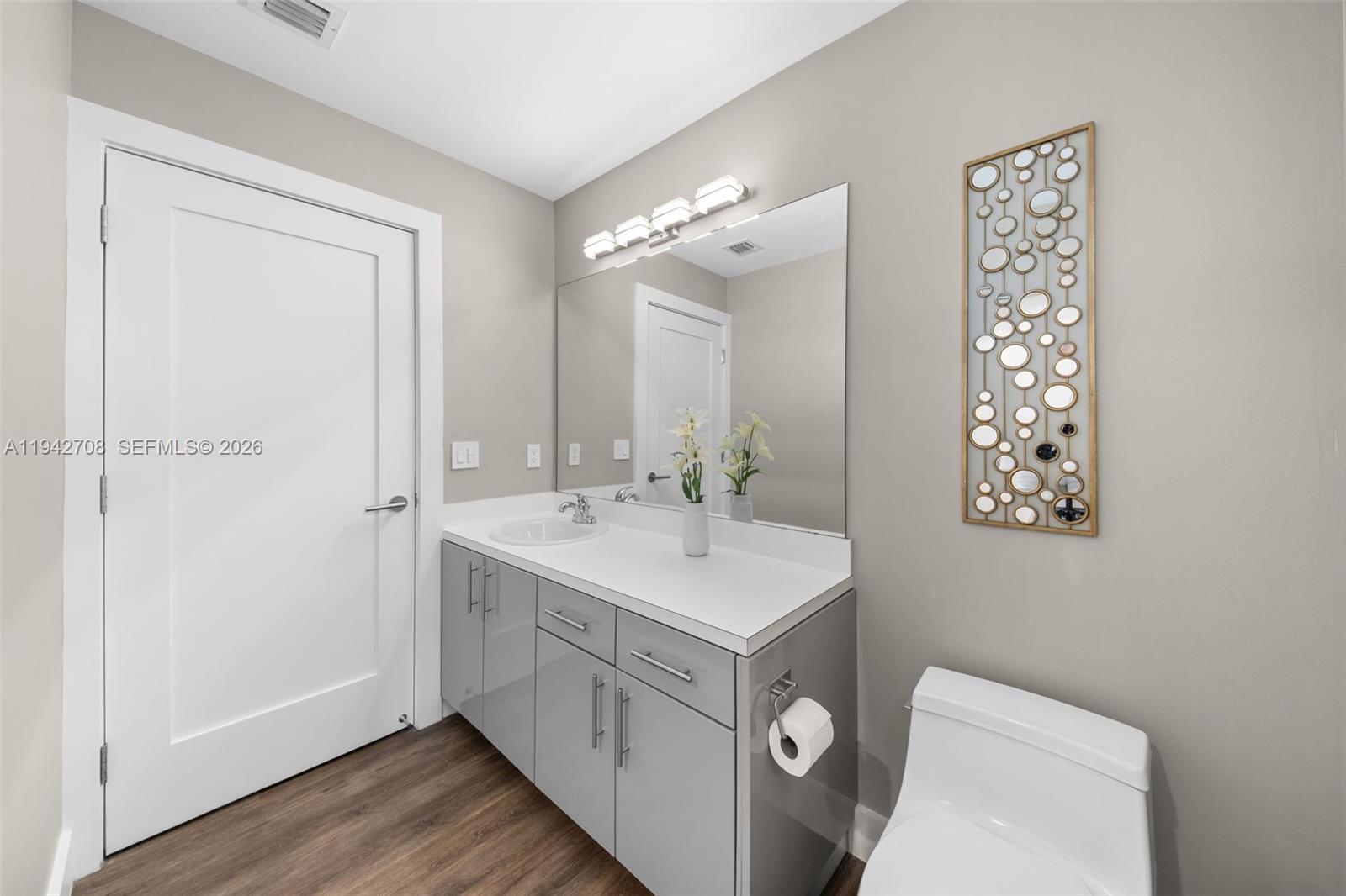 22239 Southwest 98th Place Cutler Bay, FL 33190 - Photo 40 of 67 a view of bathroom with a sink a toilet and a mirror