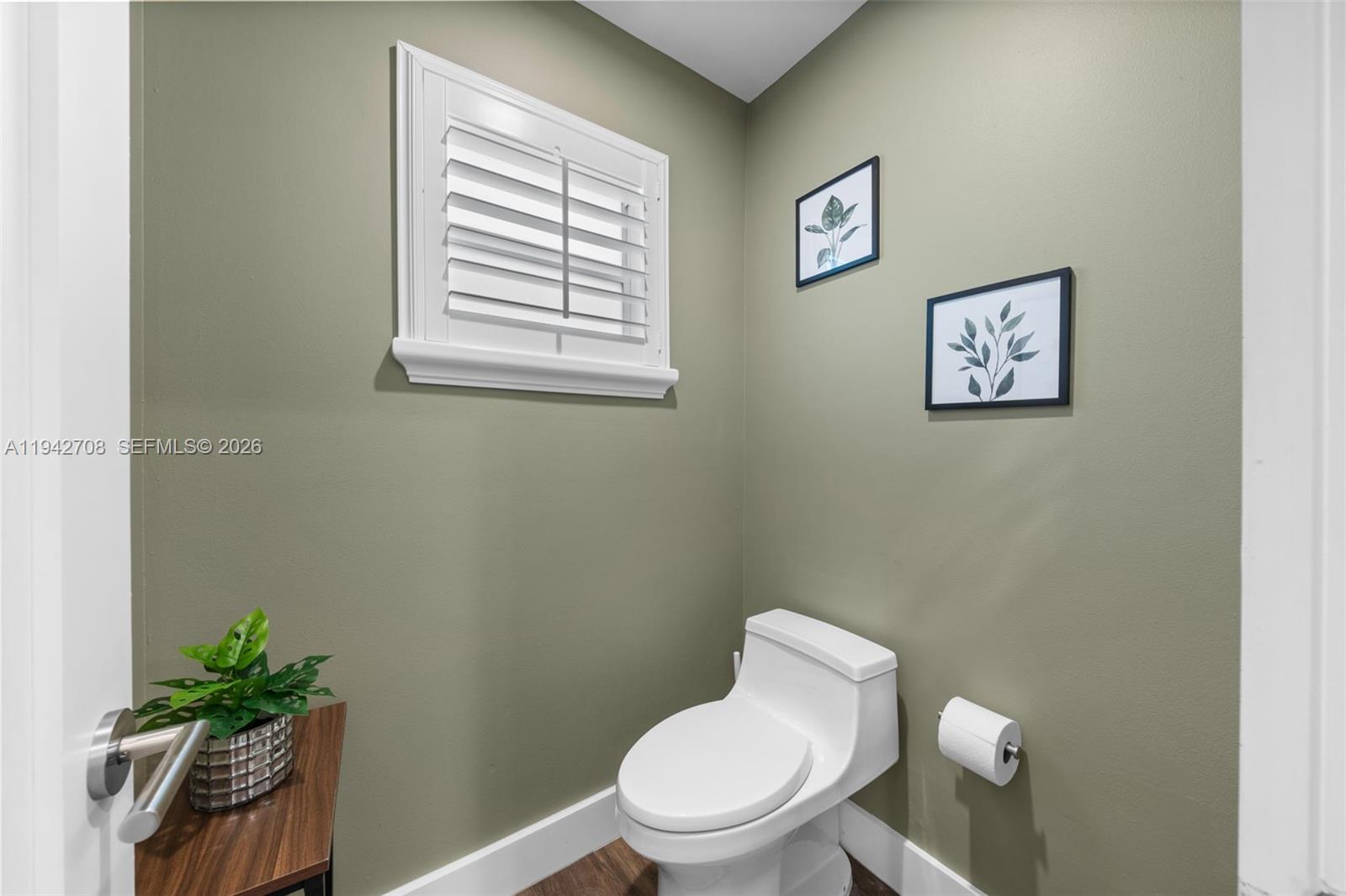 22239 Southwest 98th Place Cutler Bay, FL 33190 - Photo 41 of 67 a white toilet sitting next to a window