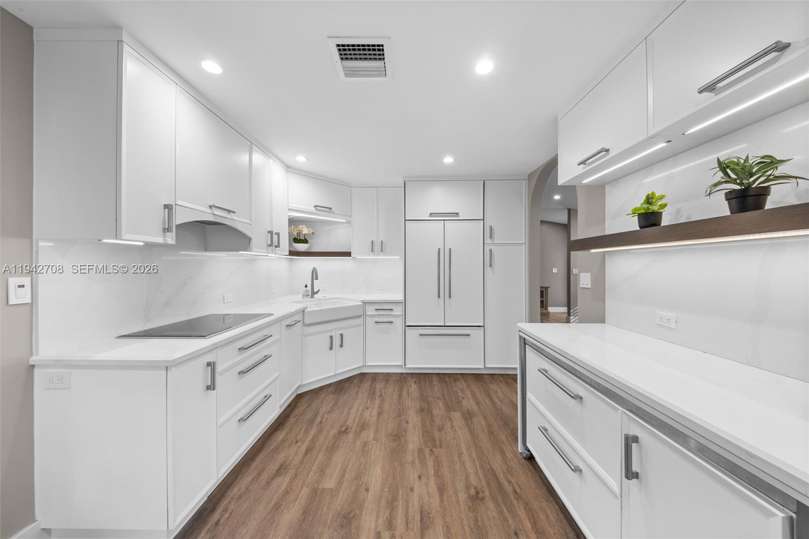 22239 Southwest 98th Place Cutler Bay, FL 33190 - Photo 50 of 67 a kitchen with a white cabinets and wooden floor