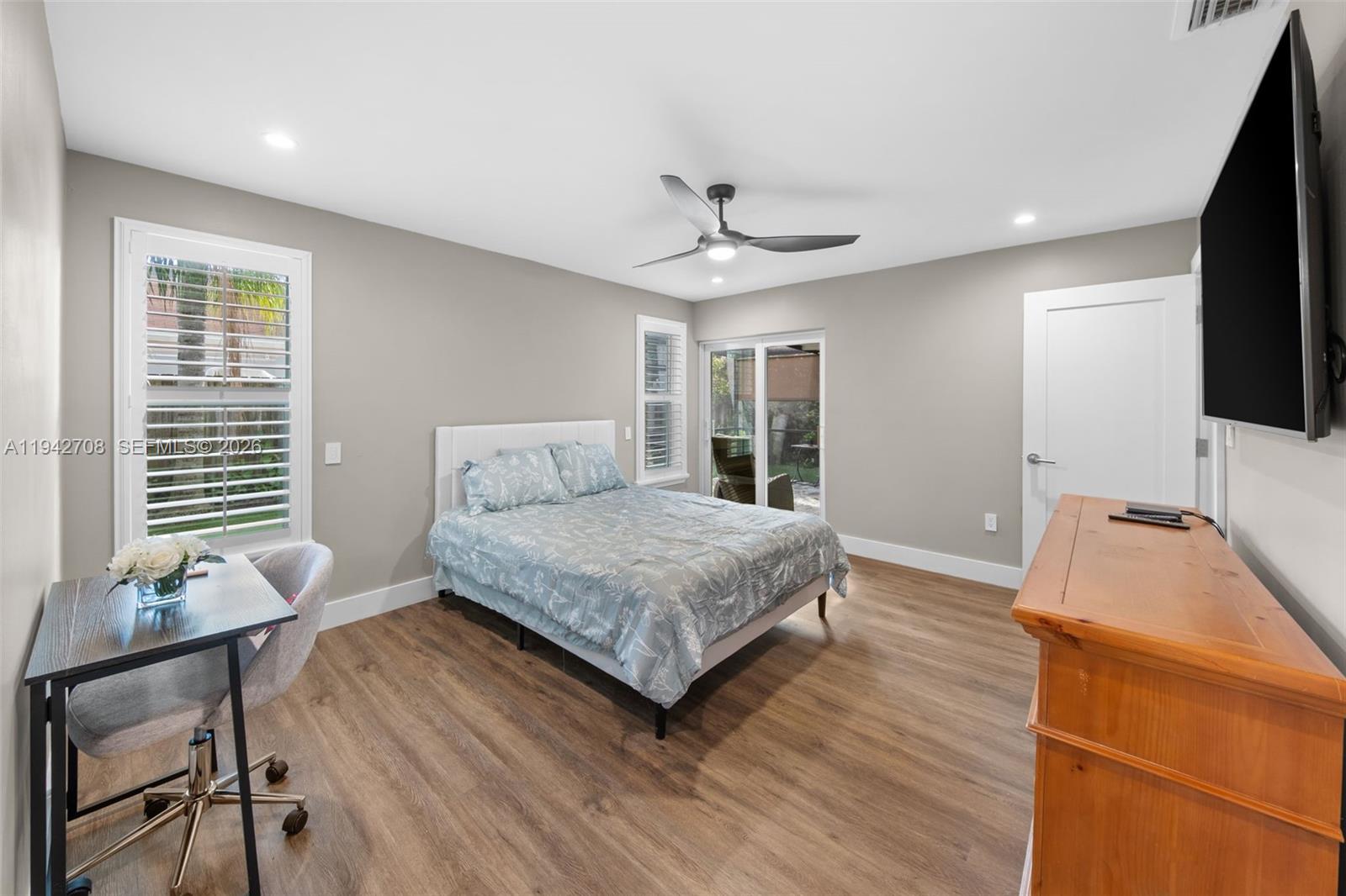 22239 Southwest 98th Place Cutler Bay, FL 33190 - Photo 5 of 67 a bedroom with a bed window and a flat screen tv