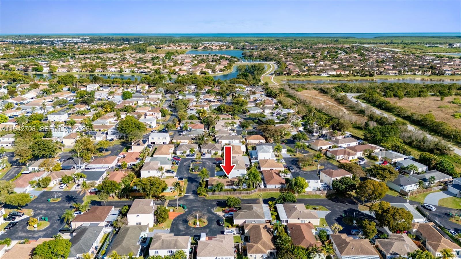 22239 Southwest 98th Place Cutler Bay, FL 33190 - Photo 66 of 67 an aerial view of residential houses with outdoor space and trees