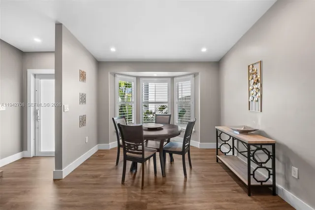 a dining room with furniture and wooden floor