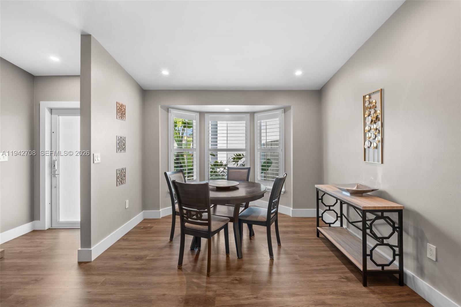 22239 Southwest 98th Place Cutler Bay, FL 33190 - Photo 10 of 67 a view of a dining room with furniture window and wooden floor