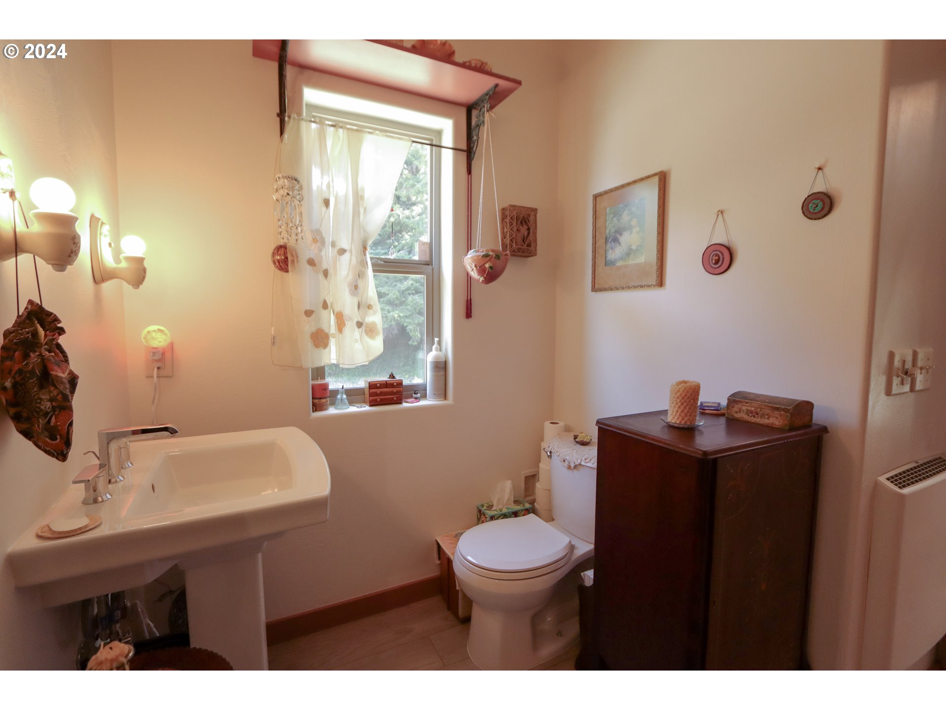 1310 Riverside Drive Northeast Bandon, OR 97411 - Photo 15 of 42 a bathroom with a sink a toilet and mirror