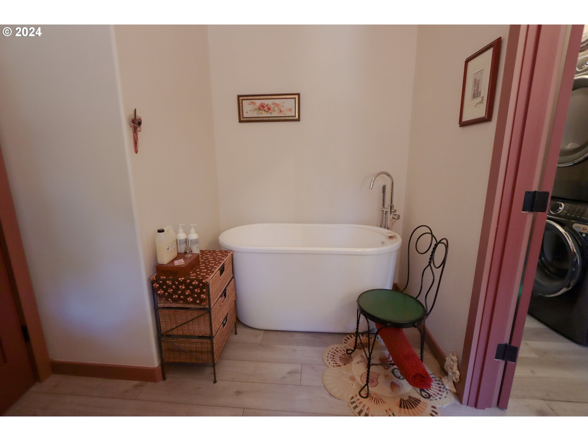 1310 Riverside Drive Northeast Bandon, OR 97411 - Photo 16 of 42 a white bath tub sitting next to a white toilet and sink