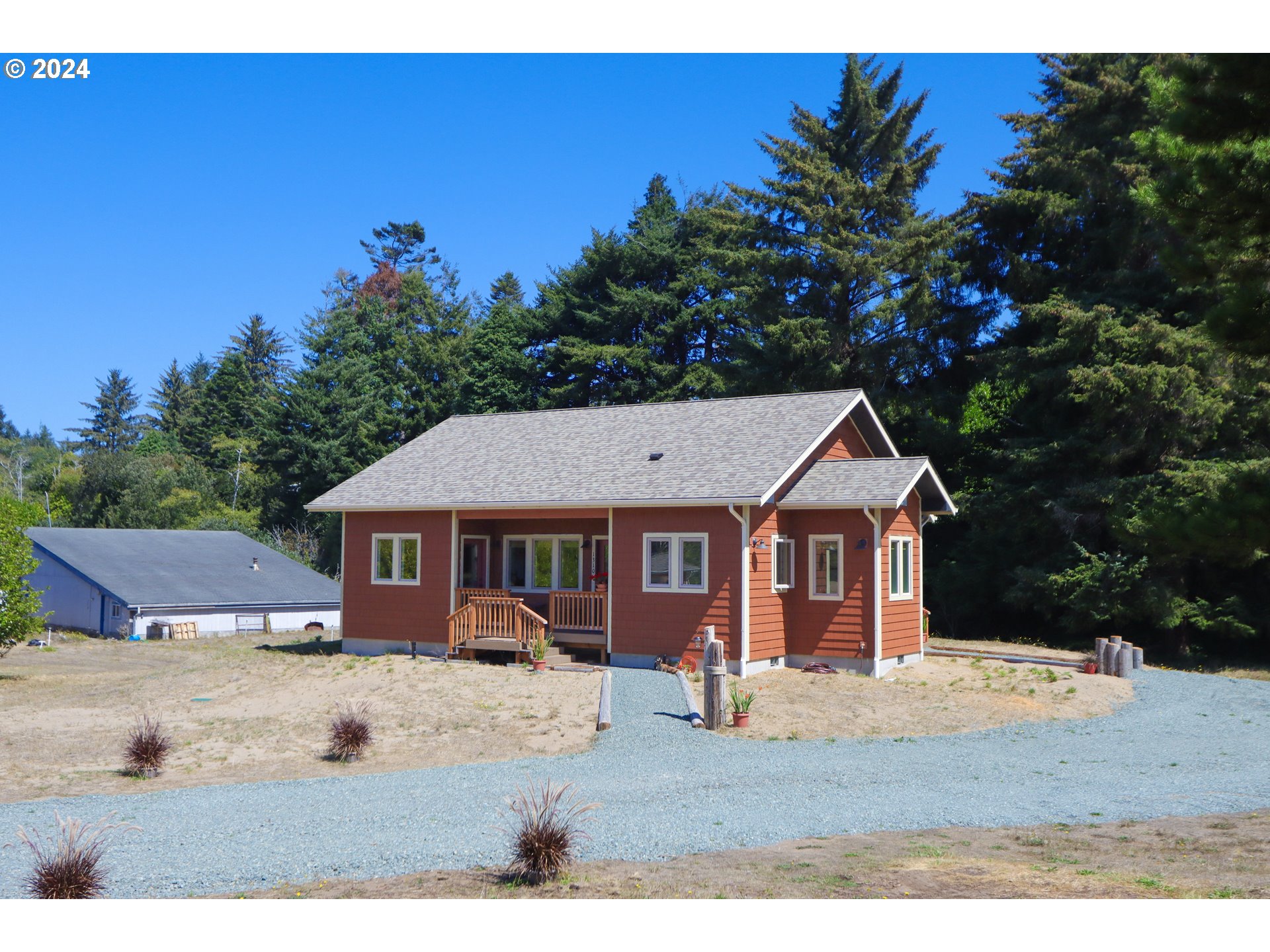 1310 Riverside Drive Northeast Bandon, OR 97411 - Photo 2 of 42 a view of a house with a backyard
