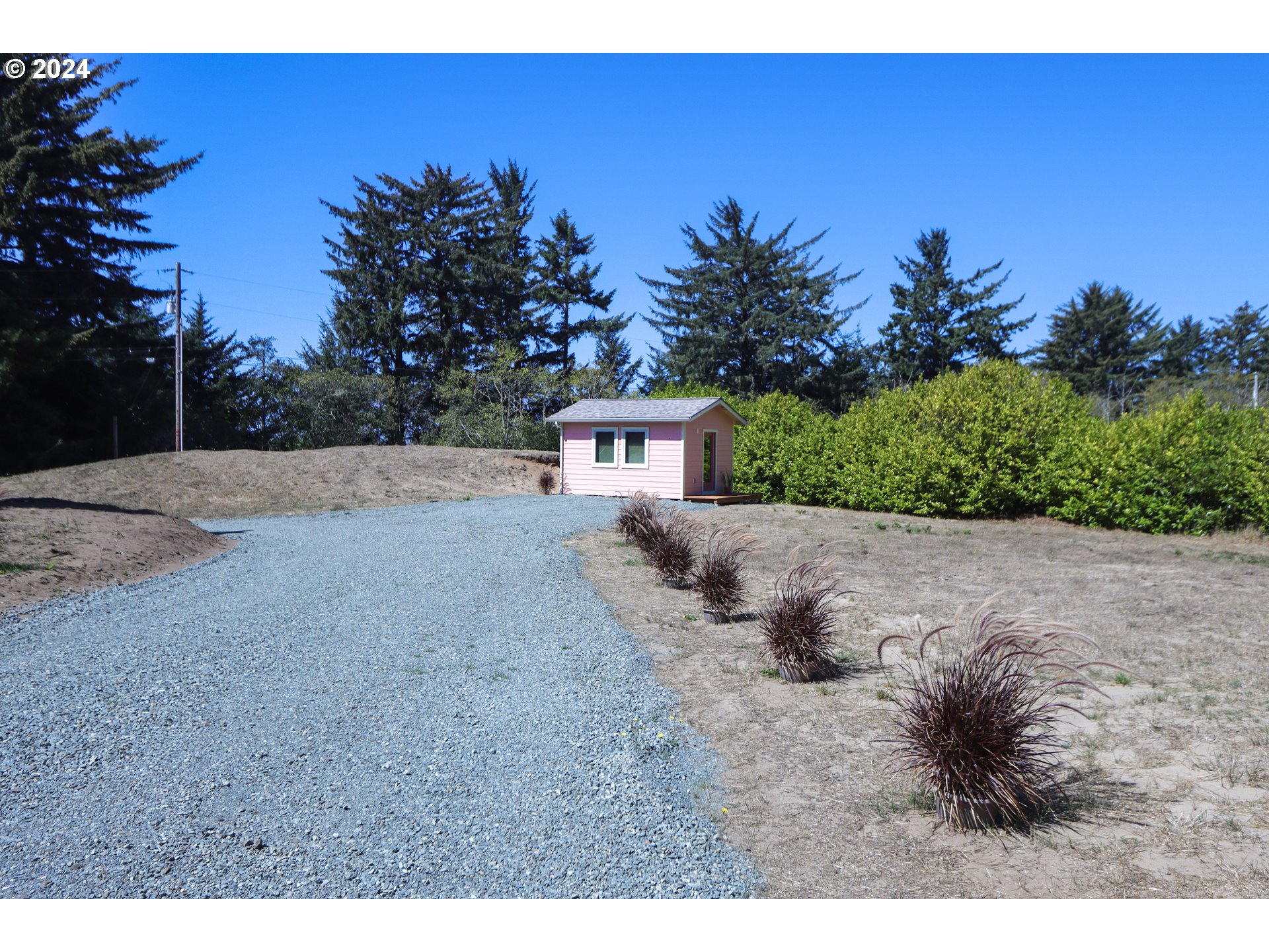 1310 Riverside Drive Northeast Bandon, OR 97411 - Photo 27 of 42 a view of a dry yard with a house