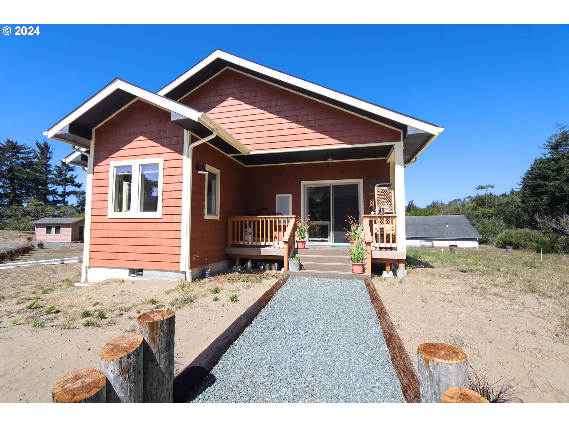 1310 Riverside Drive Northeast Bandon, OR 97411 - Photo 30 of 42 a view of a house with backyard and sitting area