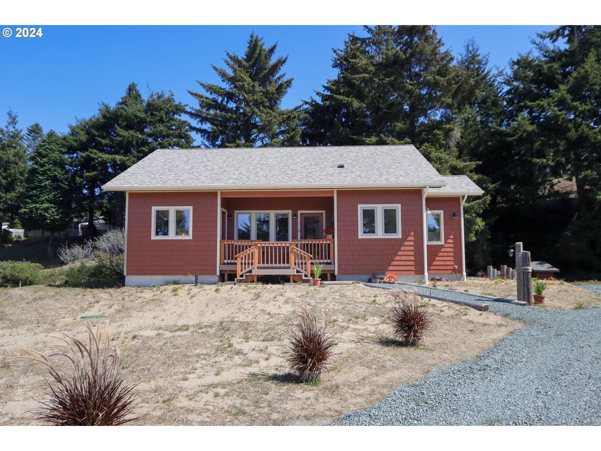 1310 Riverside Drive Northeast Bandon, OR 97411 - Photo 3 of 42 a front view of a house with a yard