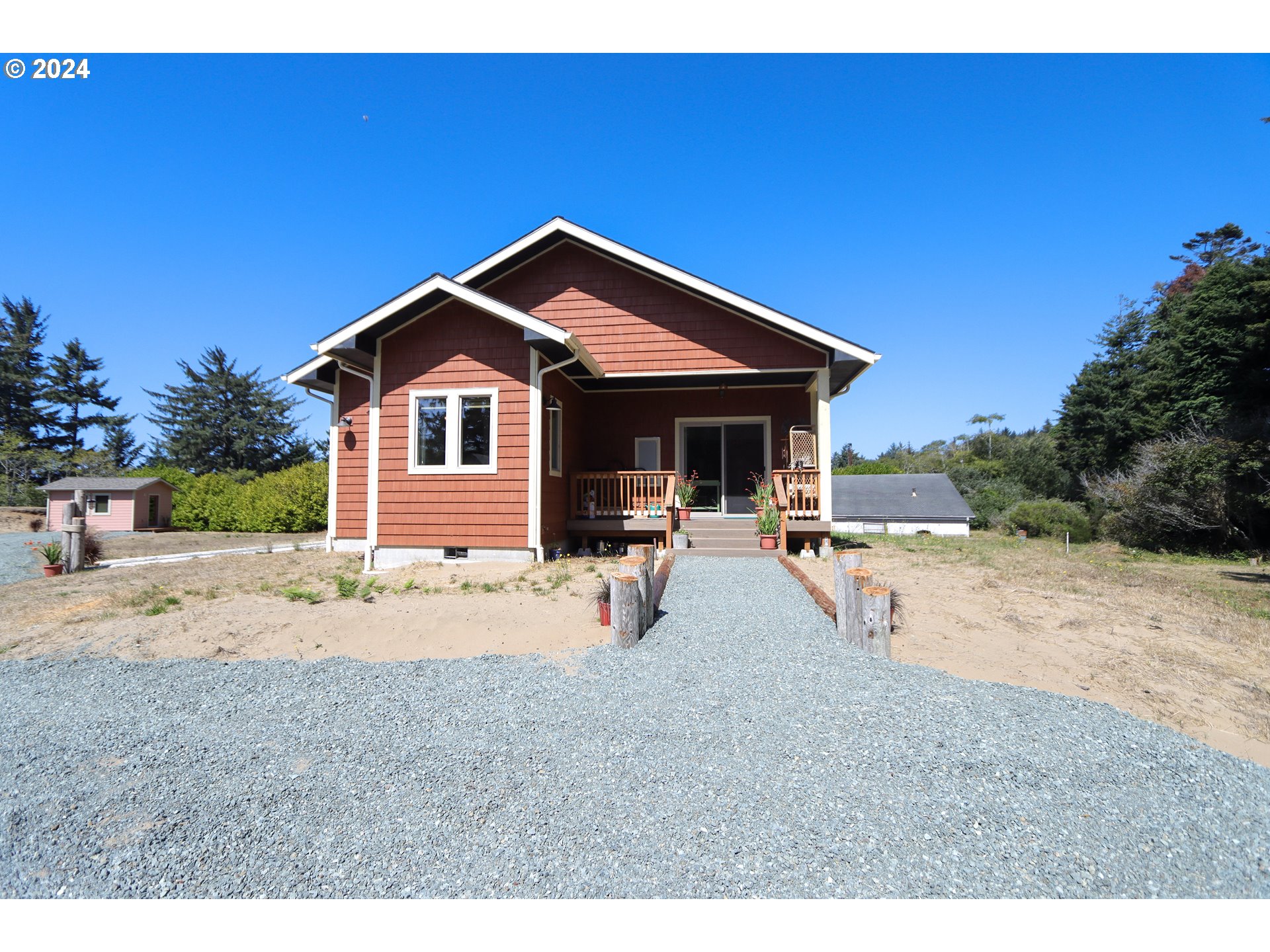 1310 Riverside Drive Northeast Bandon, OR 97411 - Photo 31 of 42 a view of a house with backyard and porch