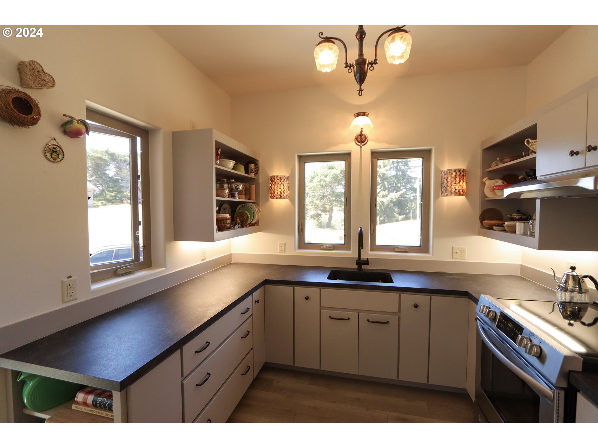 1310 Riverside Drive Northeast Bandon, OR 97411 - Photo 6 of 42 a kitchen with a sink cabinets and window