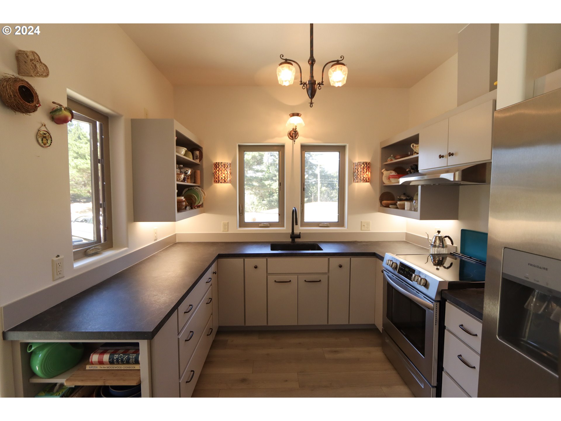1310 Riverside Drive Northeast Bandon, OR 97411 - Photo 7 of 42 a kitchen with stainless steel appliances granite countertop a sink a stove and refrigerator