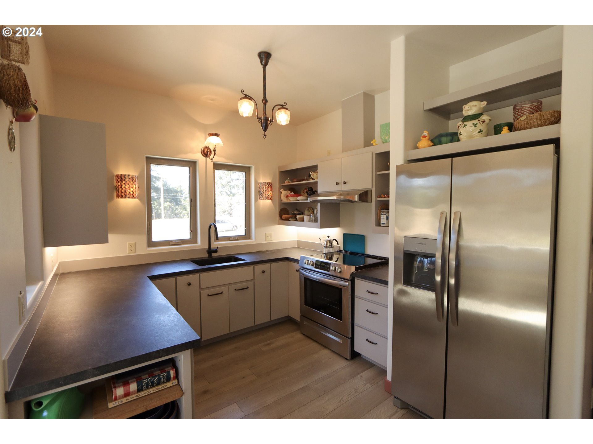 1310 Riverside Drive Northeast Bandon, OR 97411 - Photo 8 of 42 a kitchen with stainless steel appliances granite countertop a refrigerator a sink dishwasher a stove and a refrigerator