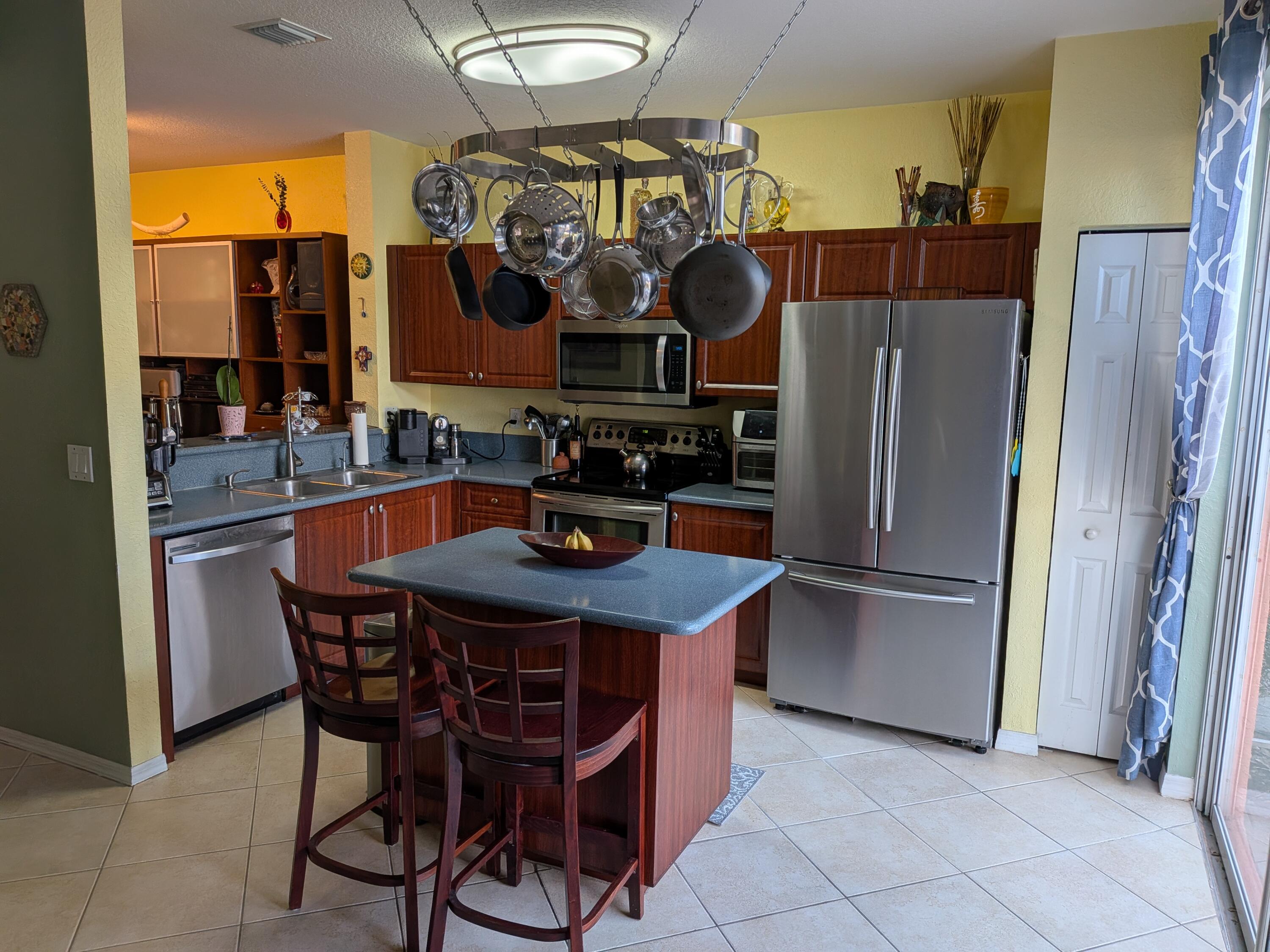 4091 Northwest 91st Terrace Sunrise, FL 33351 - Photo 12 of 41 a kitchen with a refrigerator and a stove top oven