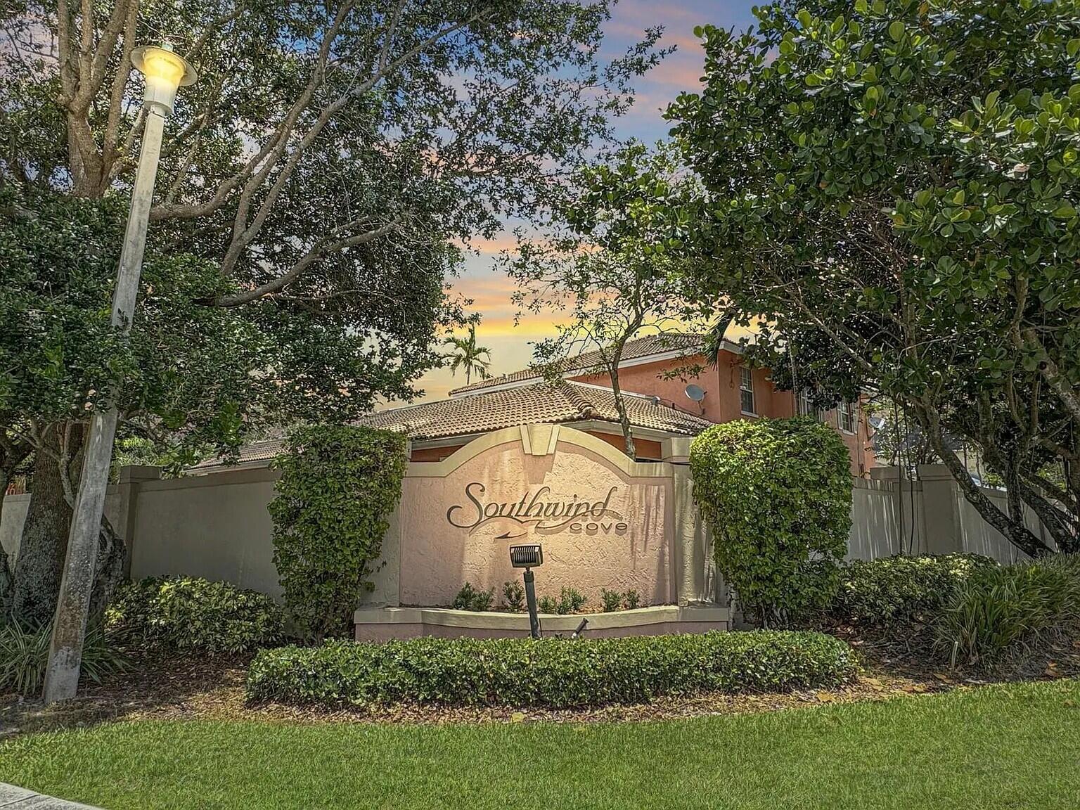 4091 Northwest 91st Terrace Sunrise, FL 33351 - Photo 2 of 41 a sign of golf club on a wall under a large tree