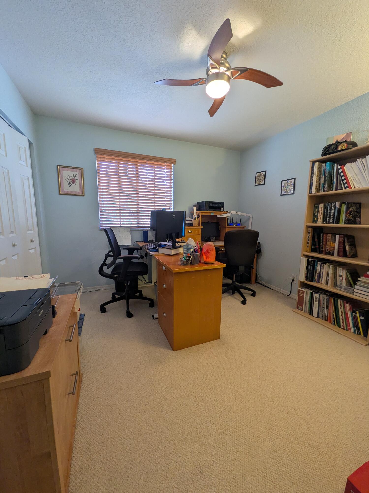 4091 Northwest 91st Terrace Sunrise, FL 33351 - Photo 23 of 41 a view of a workspace with furniture and a bookshelf