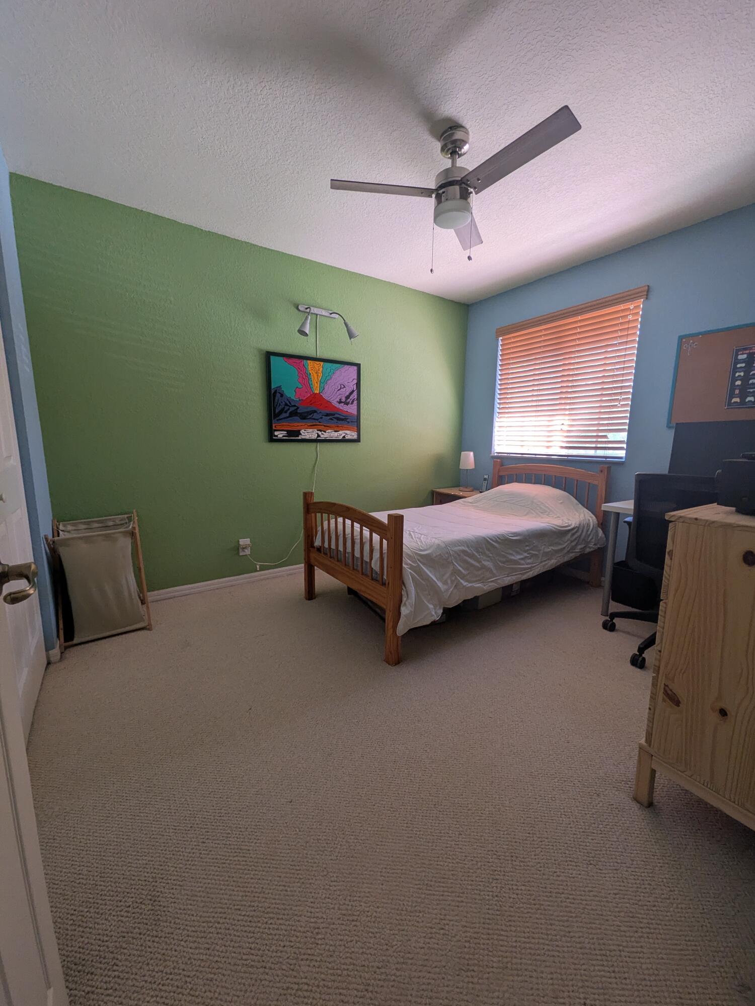 4091 Northwest 91st Terrace Sunrise, FL 33351 - Photo 24 of 41 a bedroom with a bed and a chandelier
