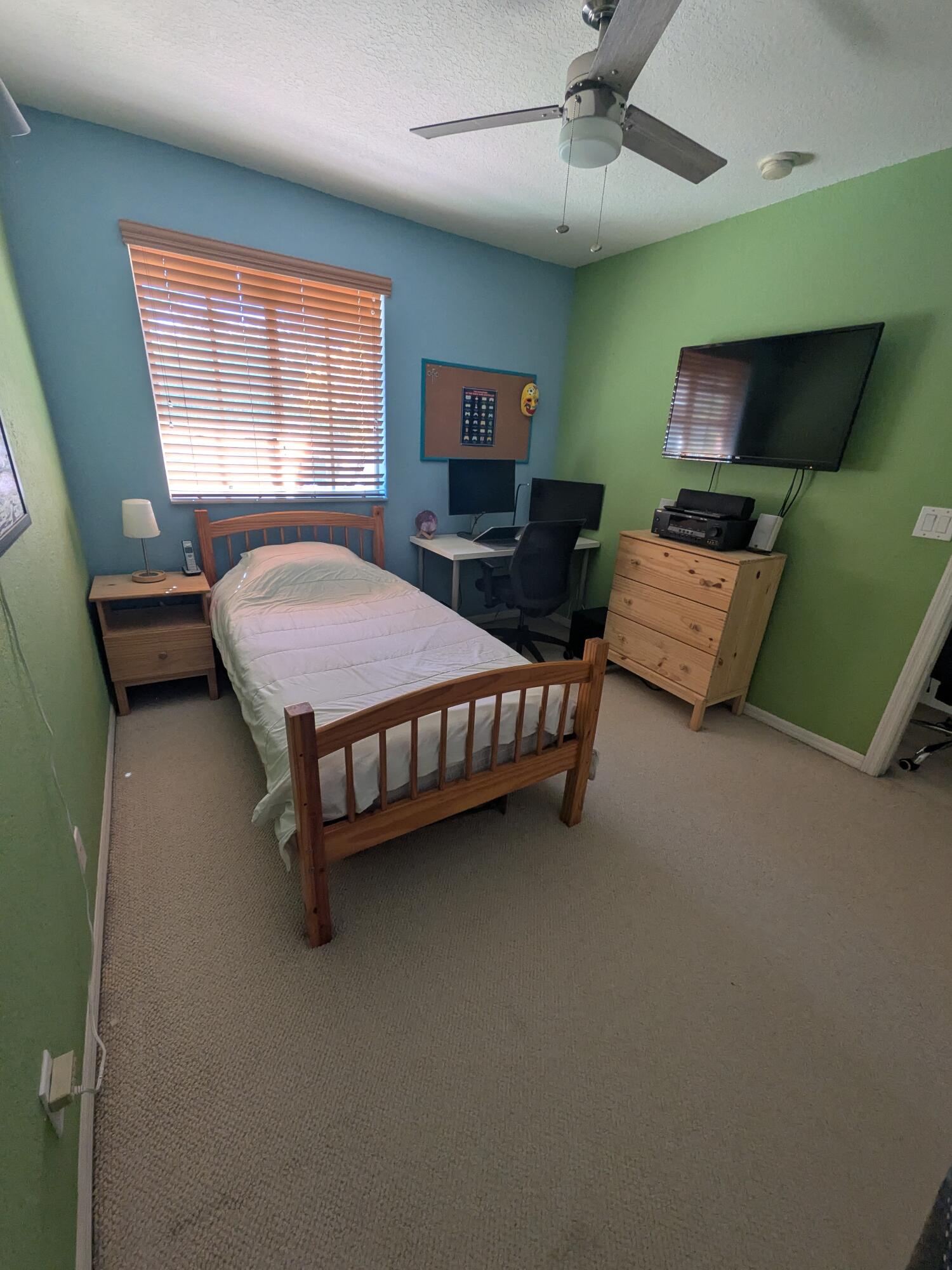 4091 Northwest 91st Terrace Sunrise, FL 33351 - Photo 25 of 41 a bedroom with a bed window and flat screen tv