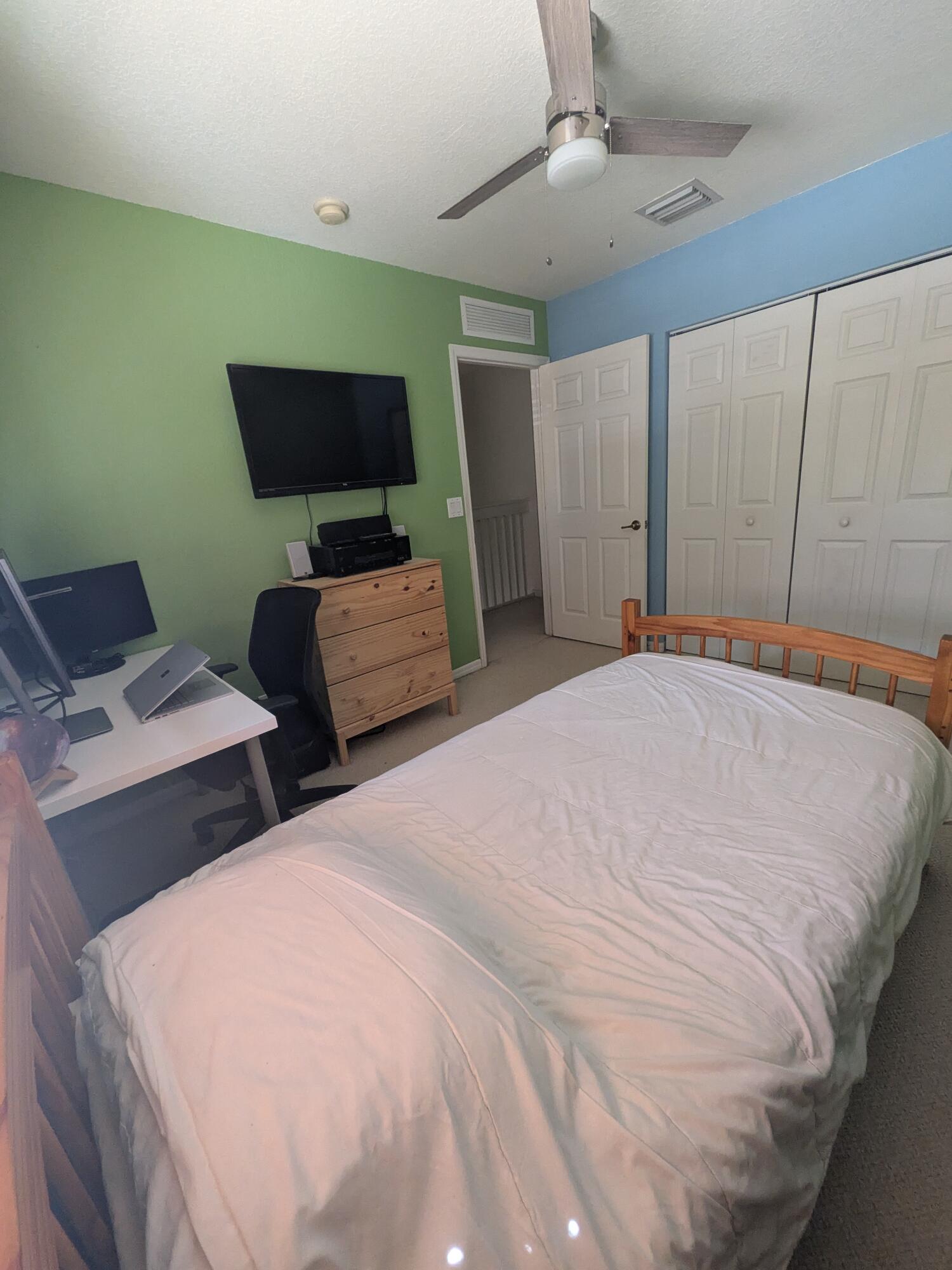 4091 Northwest 91st Terrace Sunrise, FL 33351 - Photo 26 of 41 a bedroom with two beds and a flat screen tv