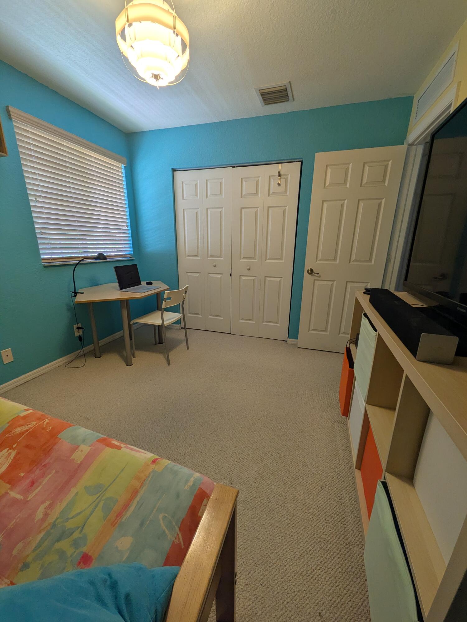 4091 Northwest 91st Terrace Sunrise, FL 33351 - Photo 29 of 41 a bedroom with a bed and a mirror