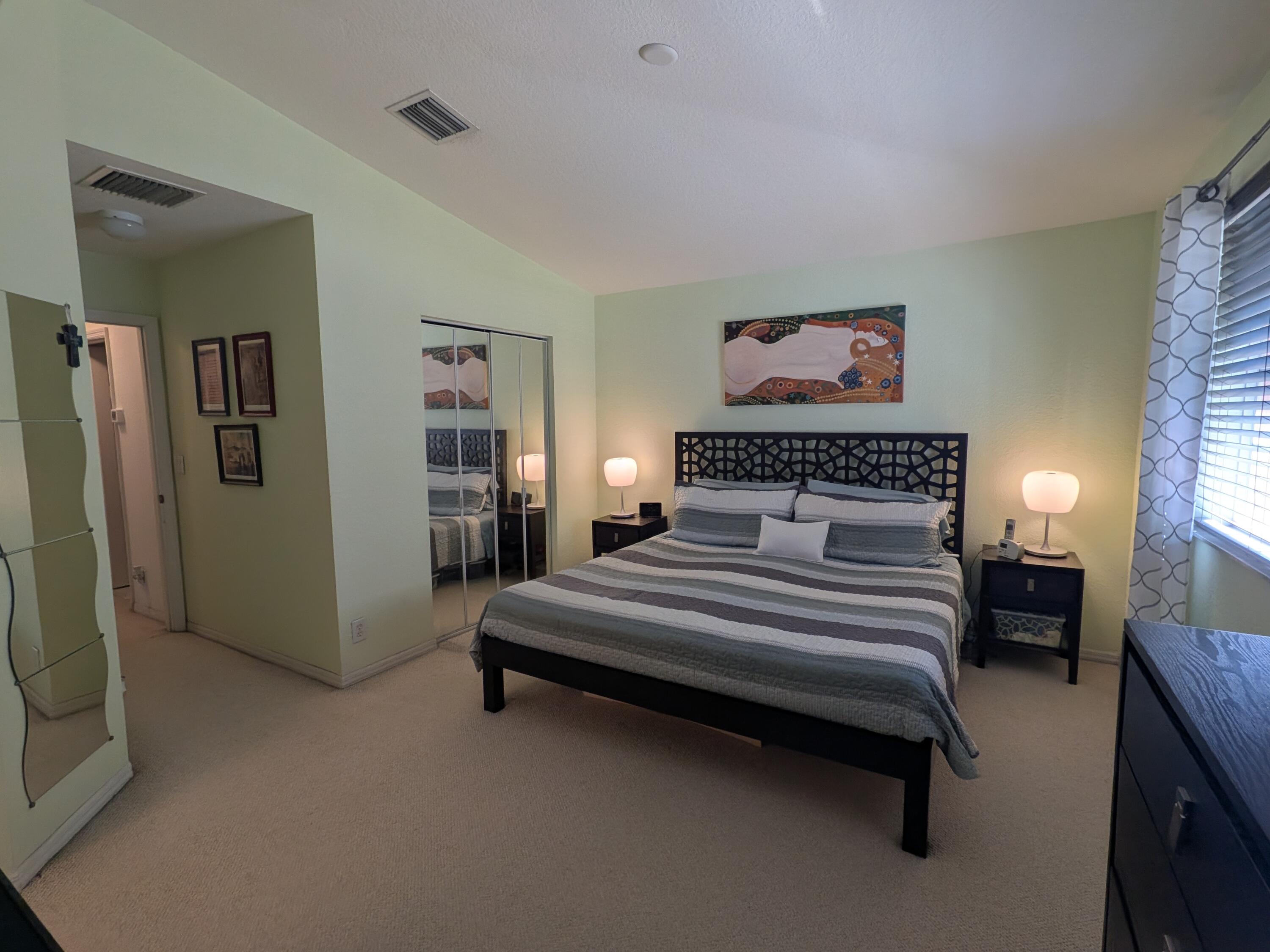 4091 Northwest 91st Terrace Sunrise, FL 33351 - Photo 33 of 41 a spacious bedroom with a bed and a chandelier