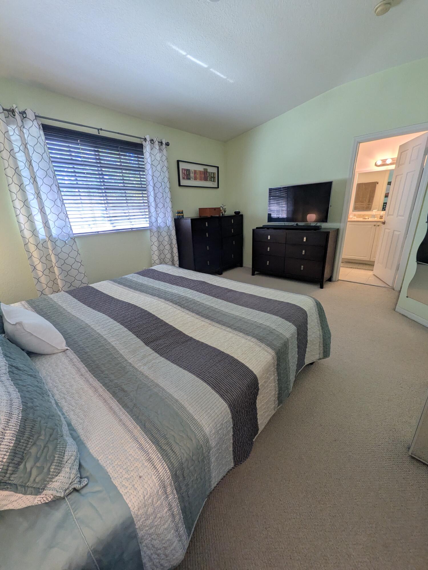 4091 Northwest 91st Terrace Sunrise, FL 33351 - Photo 35 of 41 a bedroom with a large bed and a tv