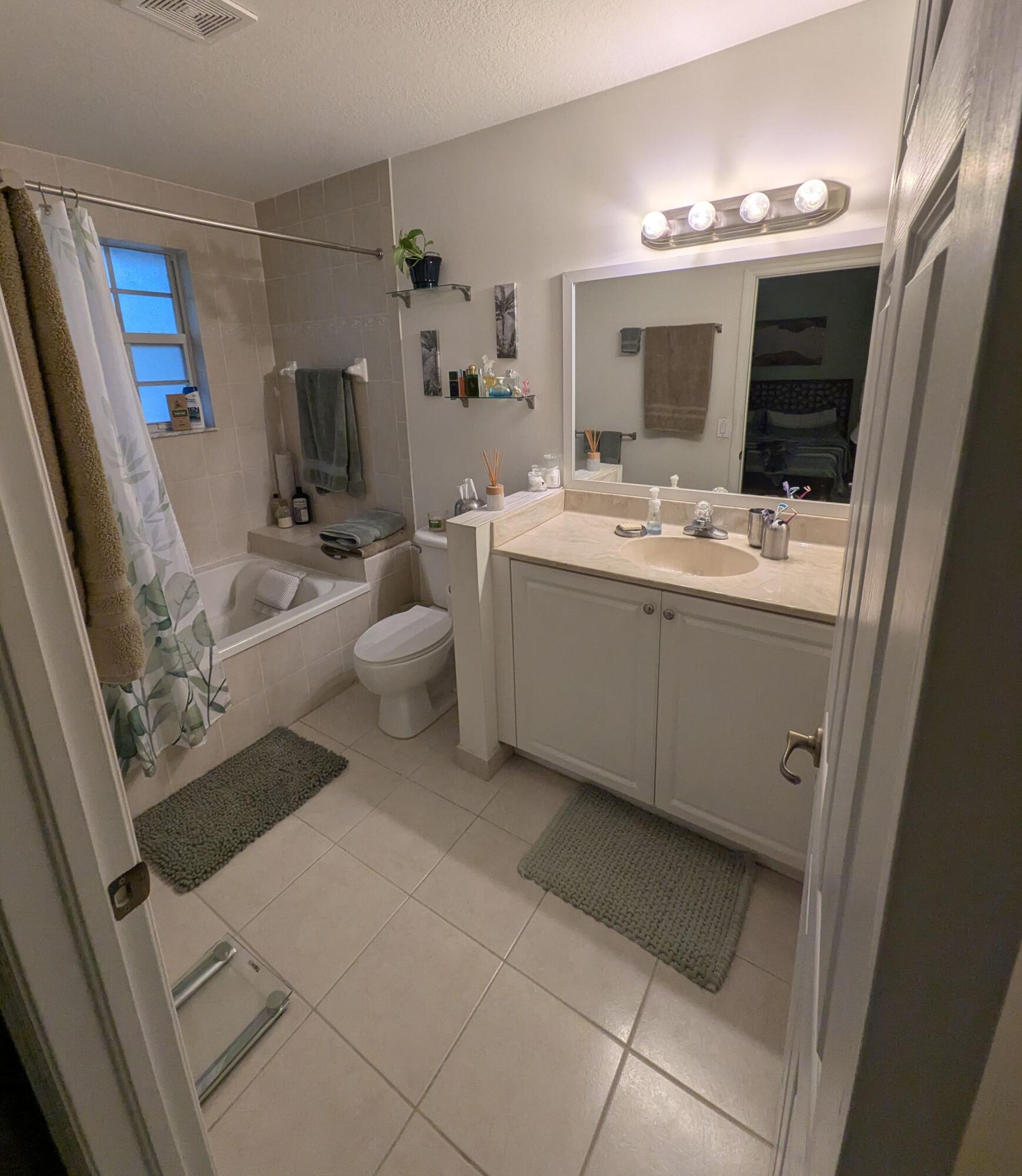 4091 Northwest 91st Terrace Sunrise, FL 33351 - Photo 38 of 41 a bathroom with a sink mirror and toilet