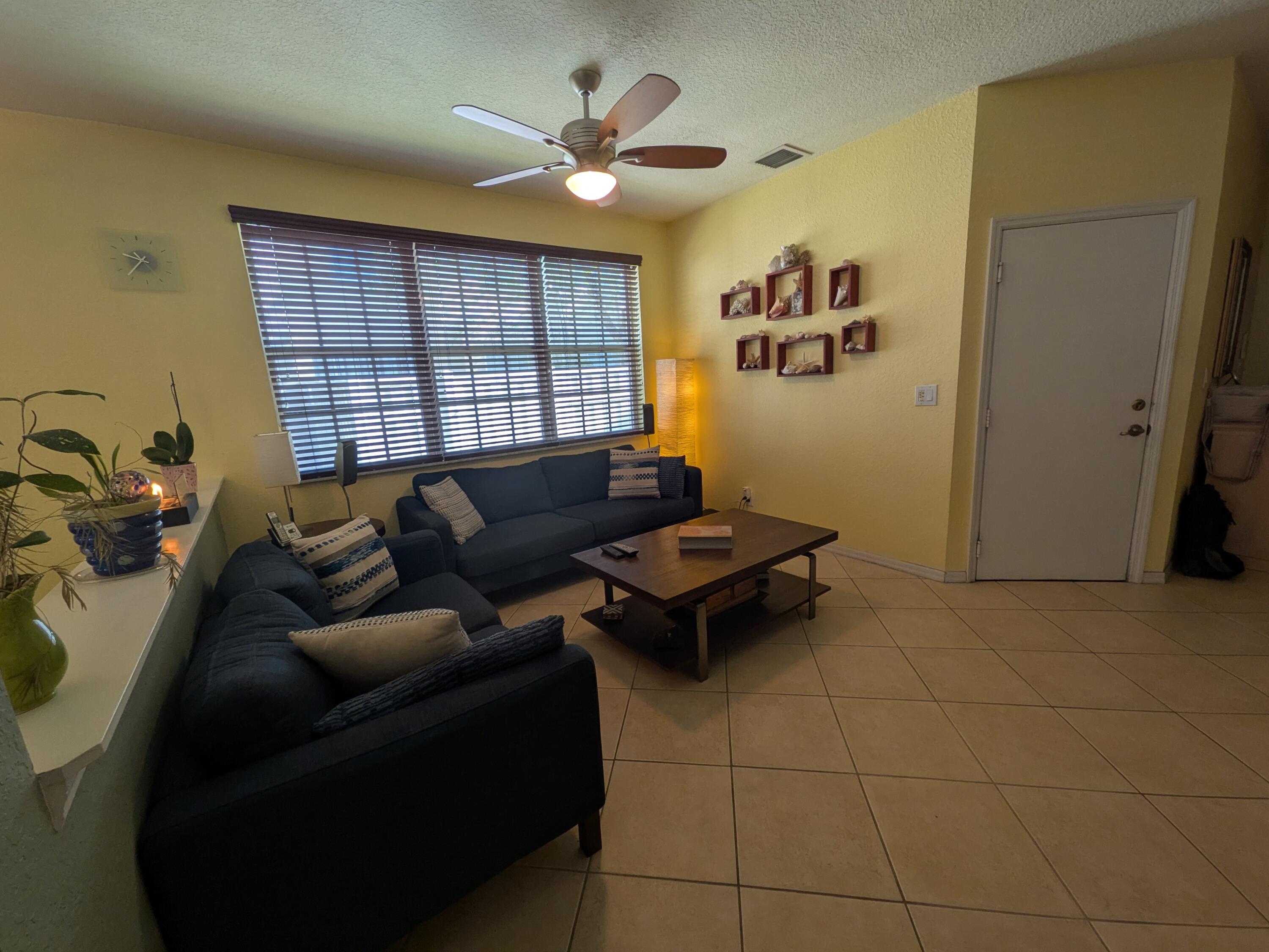 4091 Northwest 91st Terrace Sunrise, FL 33351 - Photo 7 of 41 a living room with furniture and a window