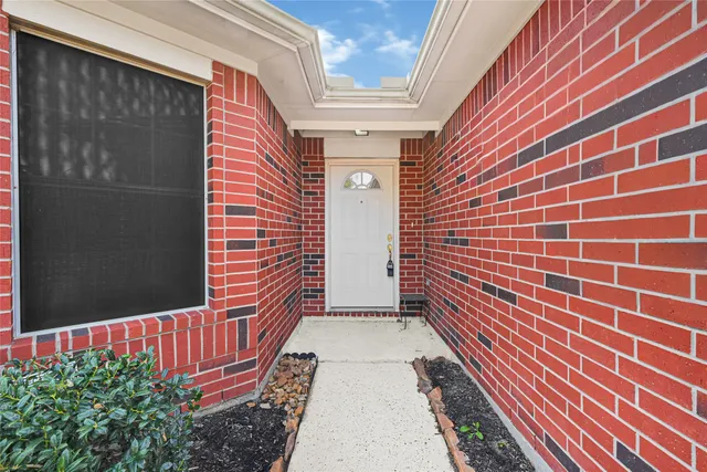 a view of a door and brick walls