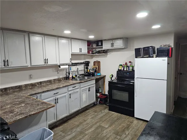 a kitchen with stainless steel appliances granite countertop a refrigerator sink and cabinets