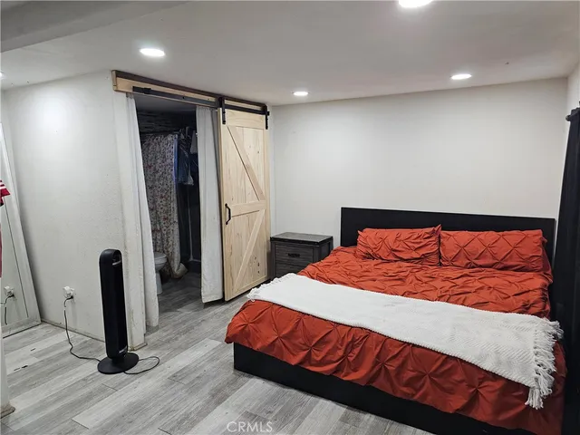 a bedroom with a bed and a mirror