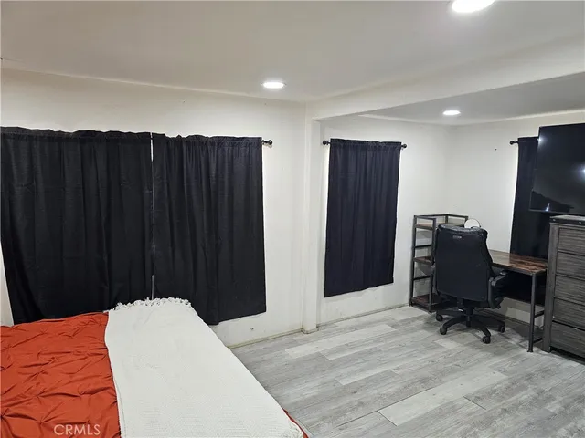 a bed room with a bed and a television