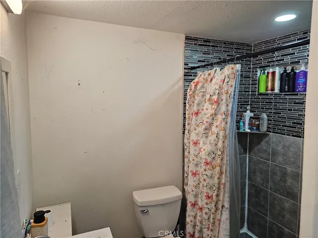 a bathroom with a shower toilet and sink