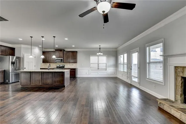 a bathroom with a granite countertop sink a mirror bathtub and shower