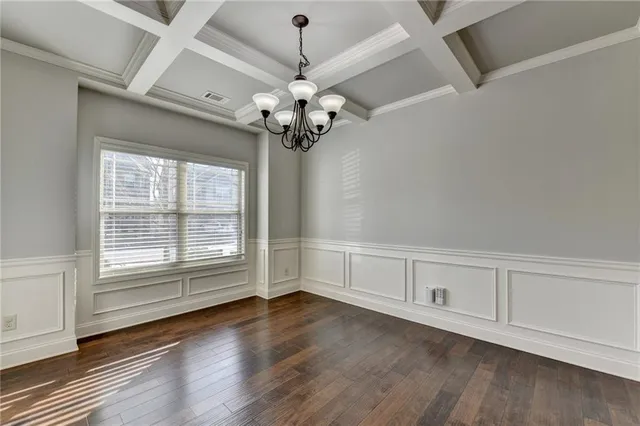 a view of a room with wooden floors and ceiling fan