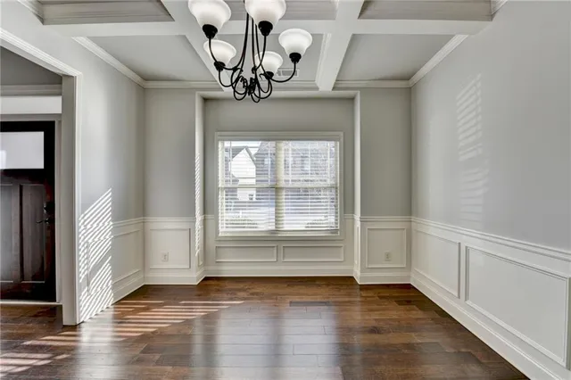 a large kitchen with kitchen island a sink dishwasher a stove a oven a dining table and chairs with wooden floor