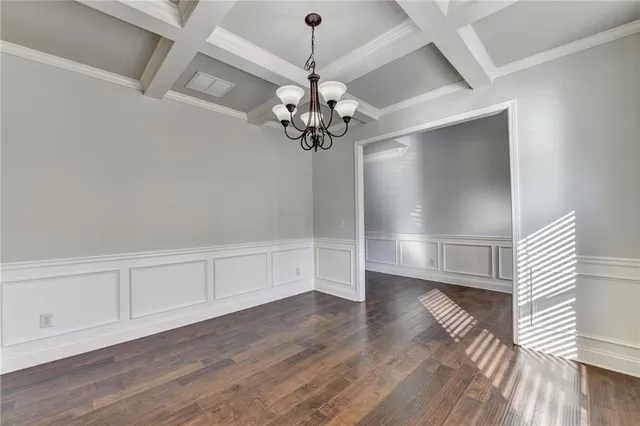 a kitchen with stainless steel appliances granite countertop wooden cabinets granite counter tops and a hard wood floors