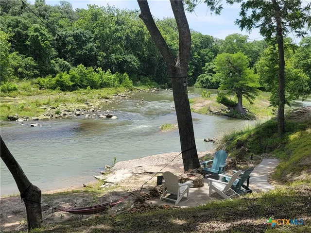 a view of a house with a yard porch and sitting area