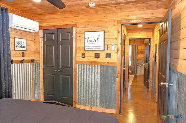 a large bed sitting in a bedroom next to a window
