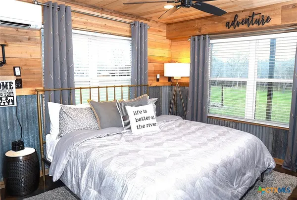 a bed sitting in a bedroom next to a window