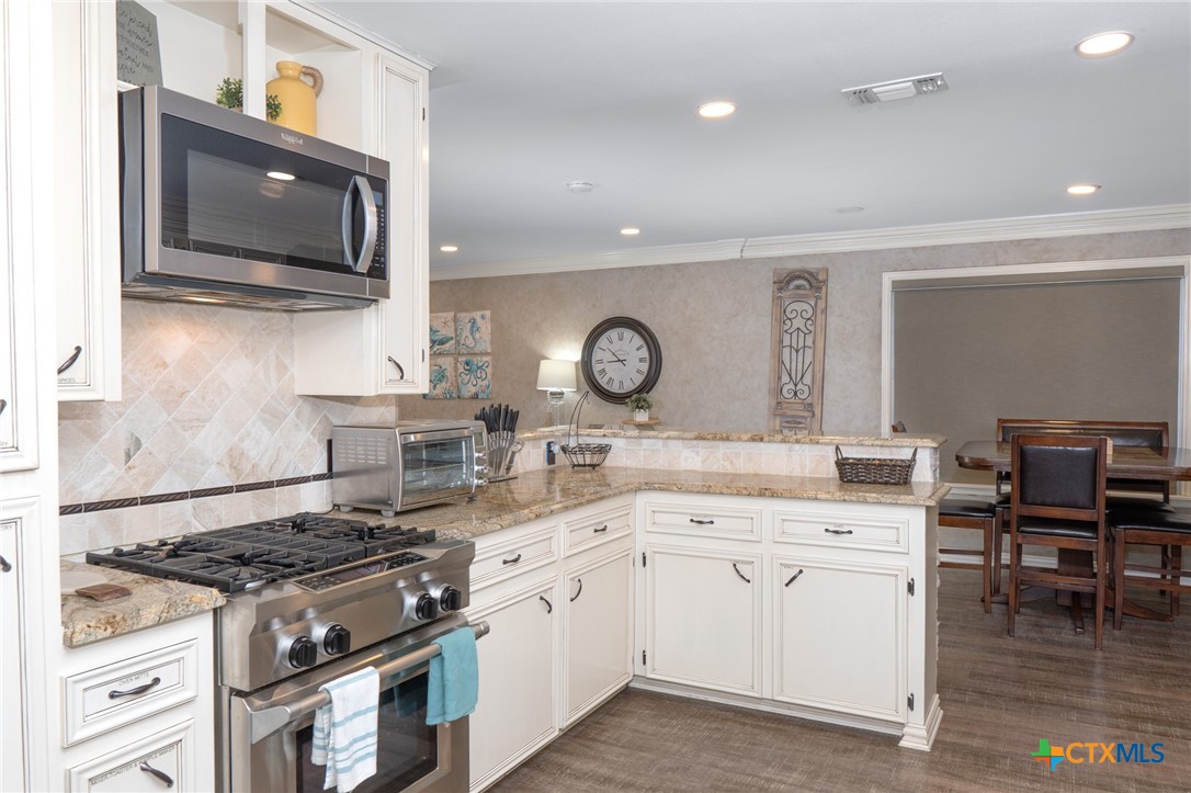 582 Cypress Valley Road Cuero, TX 77954 - Photo 32 of 36 a kitchen with a stove and a microwave