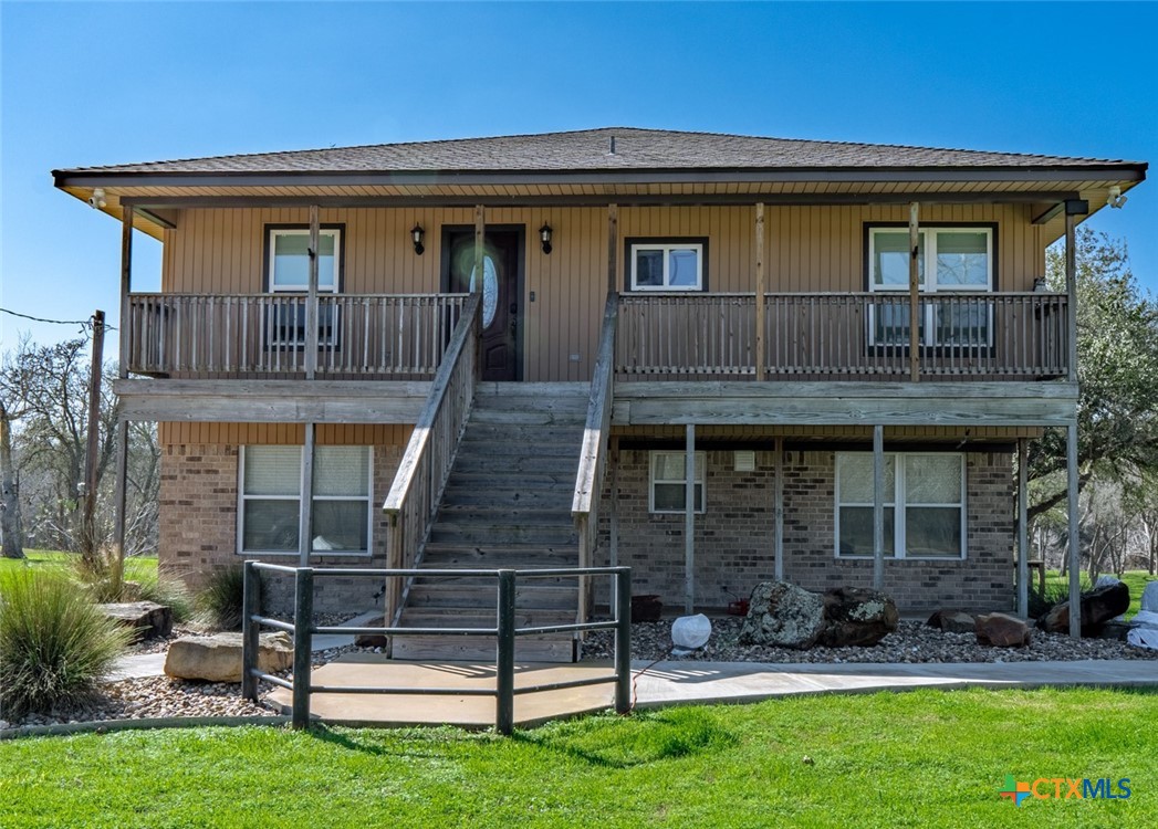 582 Cypress Valley Road Cuero, TX 77954 - Photo 4 of 36 a front view of a house with garden