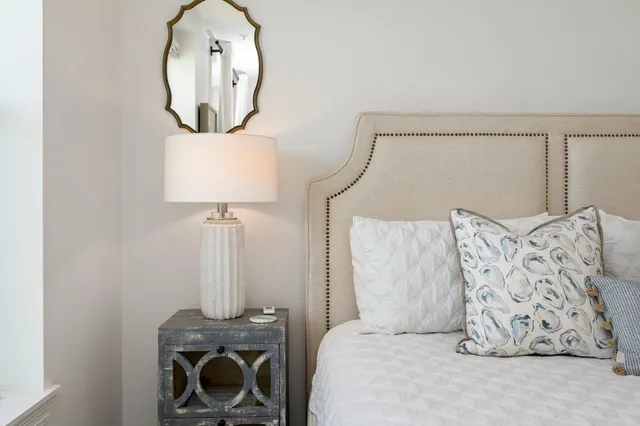 a bedroom with a bed and a mirror