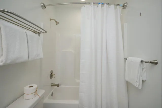 a bathroom with a shower a toilet and sink