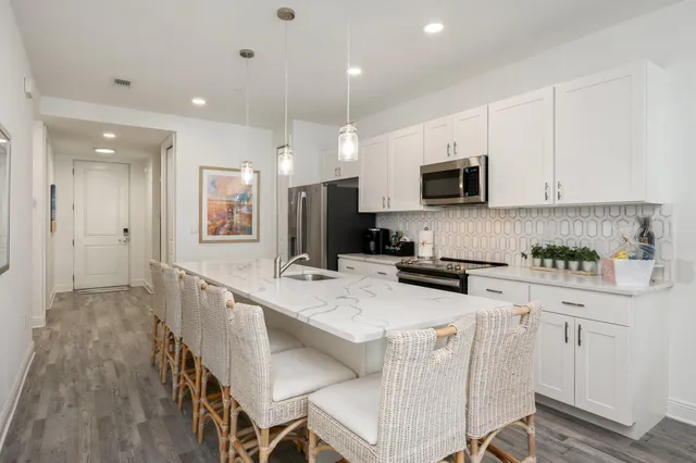 a kitchen with white cabinets and stainless steel appliances