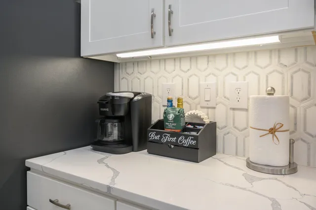 a kitchen with stainless steel appliances kitchen island granite countertop a refrigerator and a stove