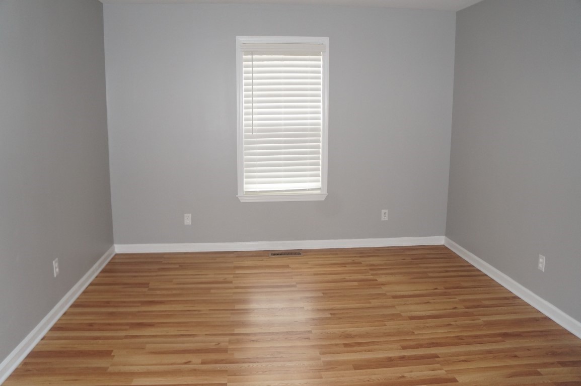 345 Yoakum Street Dayton, TN 37321 - Photo 14 of 22 a view of an empty room with wooden floor and a window
