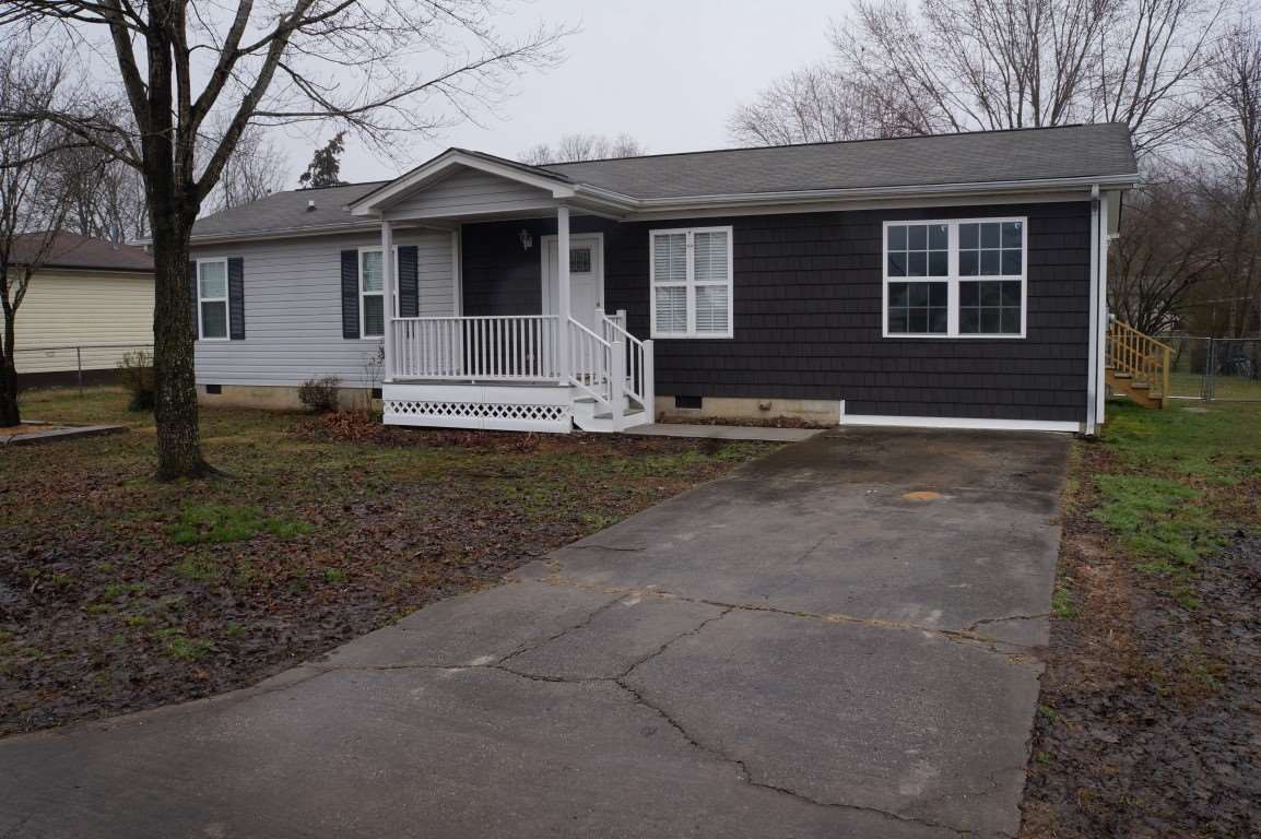 345 Yoakum Street Dayton, TN 37321 - Photo 2 of 22 a front view of a house with garden